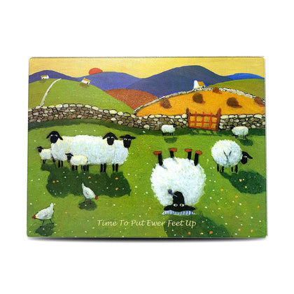 Cutting board with sheep resting in a field