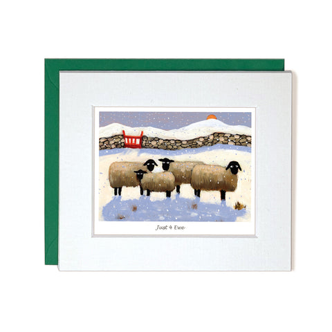 Card with mount sheep standing together during winter